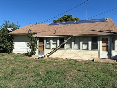 Back of property featuring a lawn and solar panels | Image 2