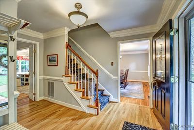 Gleaming wood floors and heavy moldings greet you | Image 2