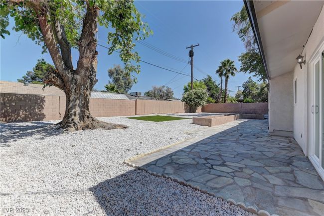 Fenced backyard with a patio area | Image 30