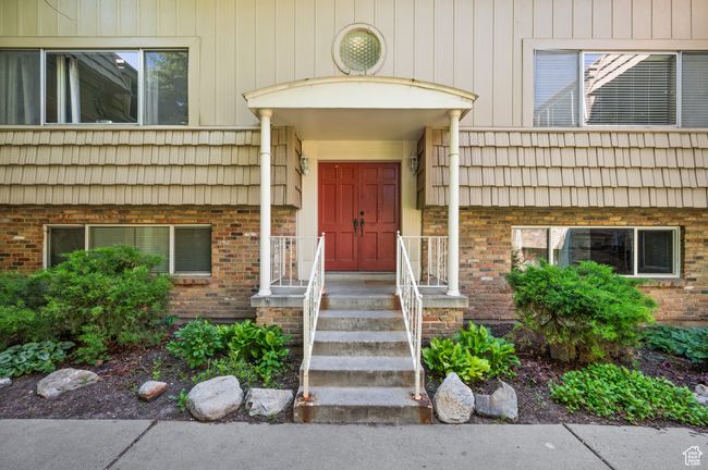 Property entrance featuring brick siding and mansard roof | Image 5