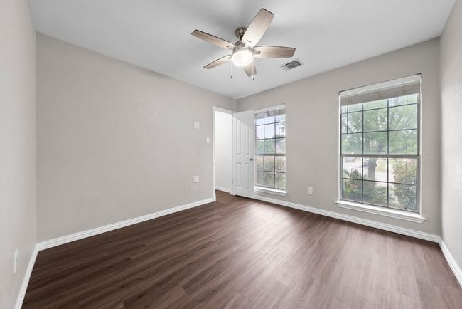 Spare room featuring baseboards, dark wood-style flooring, and a ceiling fan | Image 15