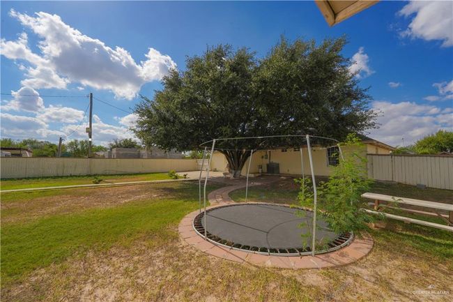 View of yard with a trampoline | Image 18