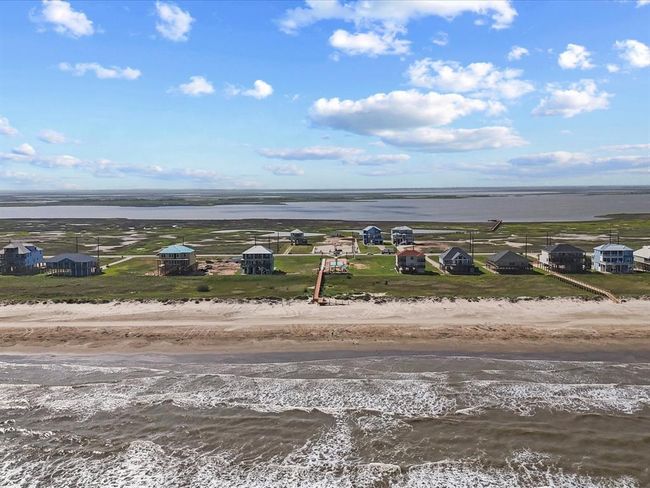 This breathtaking aerial shot tells the full story: beachfront serenity in the front, protected nature preserve and bay access in the back. The perfect blend of coastal escape and connected convenience, all just an hour south of Houston. | Image 6