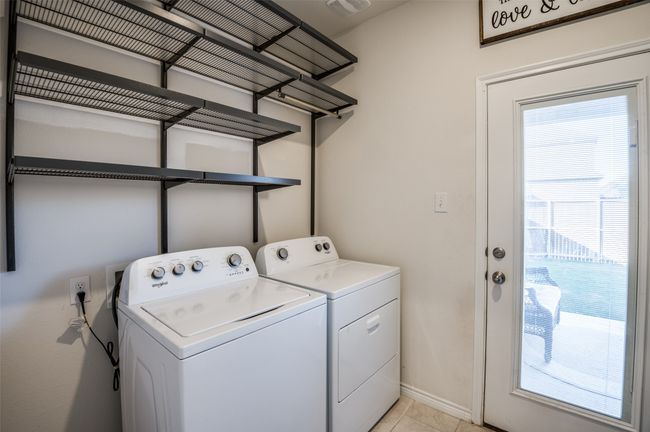 Laundry room with laundry area, baseboards, plenty of natural light, and washing machine and dryer | Image 23