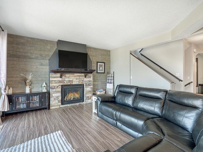 Gas fireplace with stone surround makes for cozy evenings. | Image 14