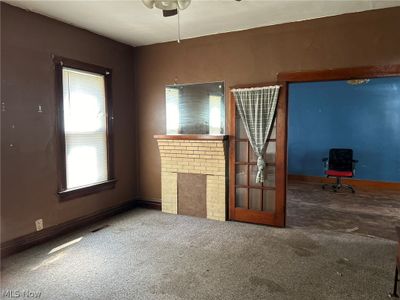 Note decorative fireplace and the French doors leading to the dining room. d | Image 3