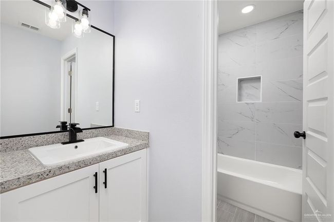 Bathroom featuring vanity, recessed lighting, and shower / bath combination | Image 8