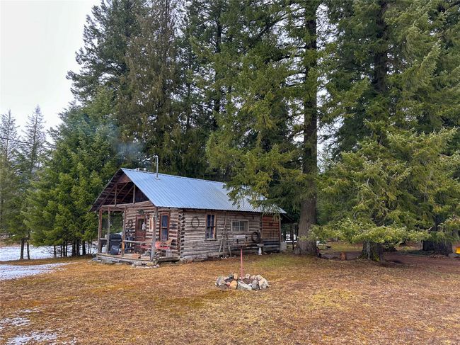 View of quest quarter's exterior featuring log siding and metal roof | Image 27