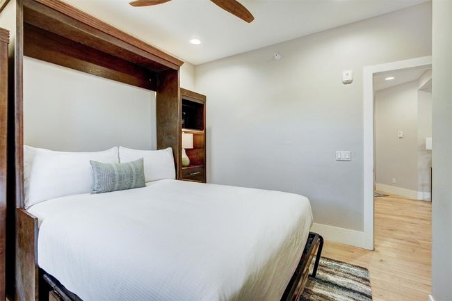 Bedroom with baseboards, recessed lighting, wood finished floors, and a ceiling fan | Image 27