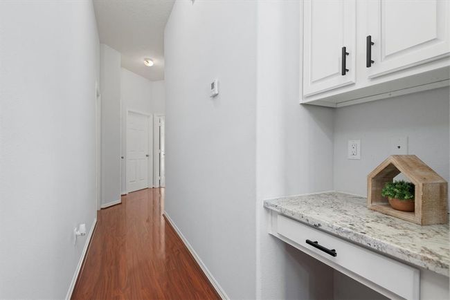 The hallway has a desk nook with storage - a perfect spot for a workstation. | Image 14