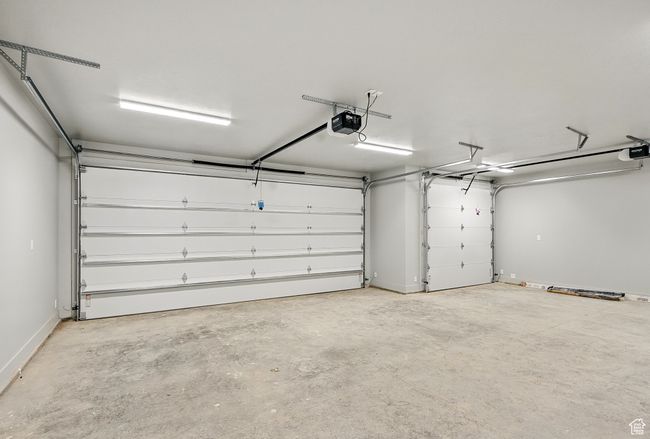 Garage with a garage door opener and baseboards | Image 48