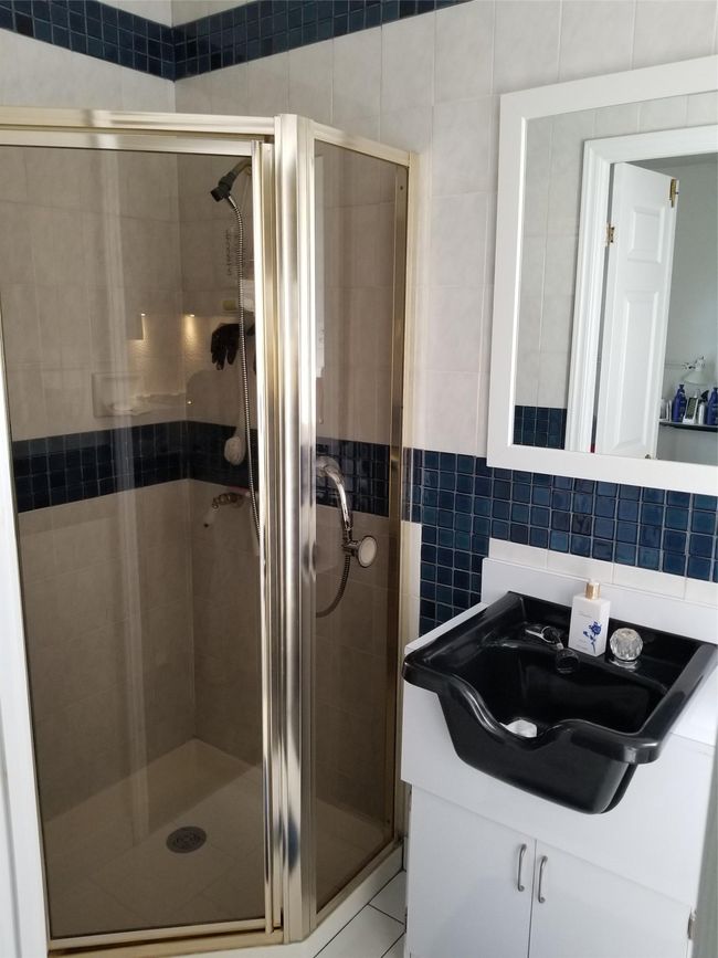 Bathroom featuring tasteful backsplash, a stall shower, tile walls, and vanity | Image 6