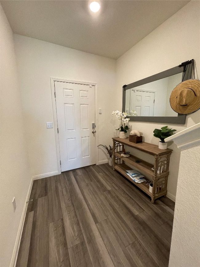 Luxury vinyl plank floors adorn the main areas of the home. | Image 6