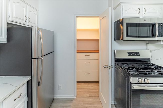 In addition to many cabinets the kitchen has a pantry | Image 4