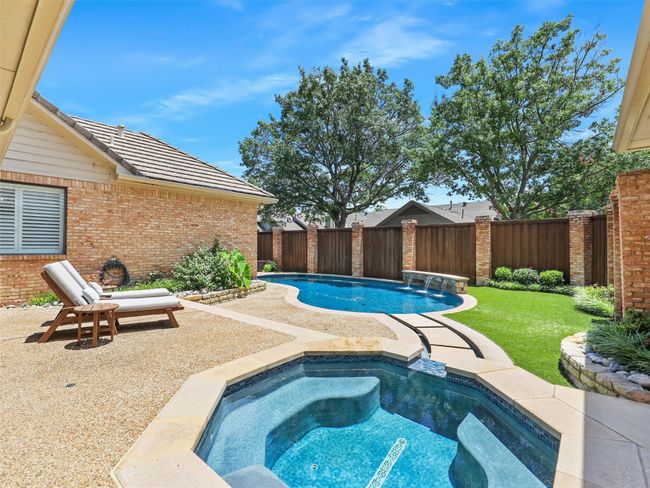 View of swimming pool featuring a fenced backyard, an in-ground hot tub, and a patio | Image 33