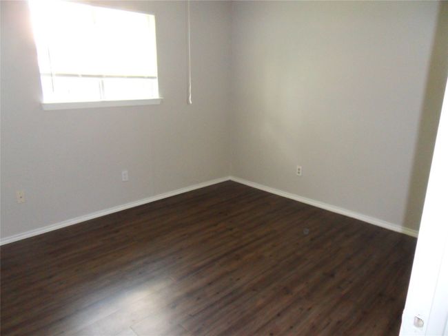 Empty room featuring dark wood finished floors and baseboards | Image 10