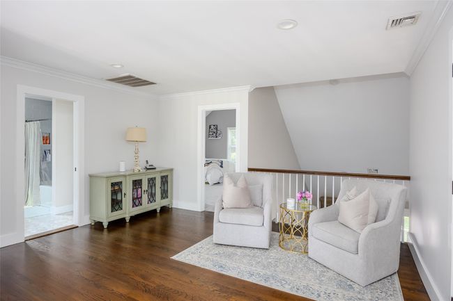 Living area with crown molding, wood finished floors, and recessed lighting | Image 20