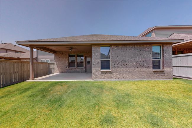 Rear view of house featuring a patio area, brick siding, and a ceiling fan | Image 30