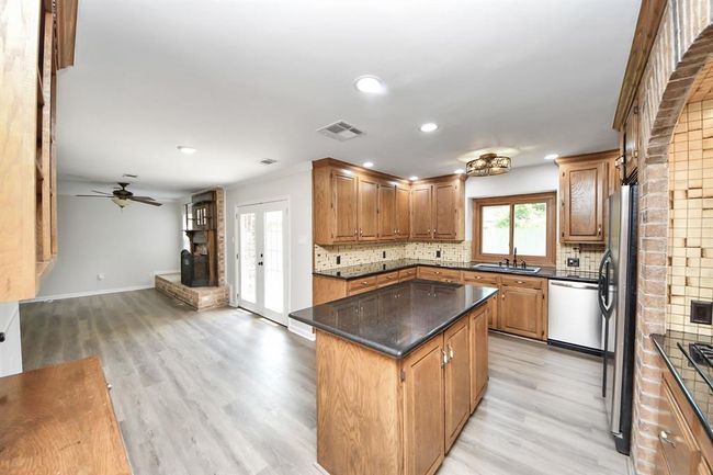 Large island with electrical outlets built in. | Image 12