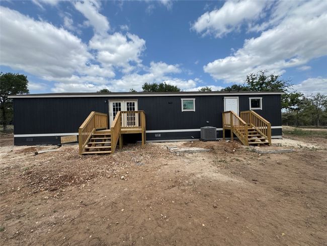 Back of property with crawl space, a deck, french doors, and central AC unit | Image 4