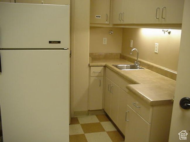 Kitchen with light floors, light countertops, Sink & Fridge | Image 15