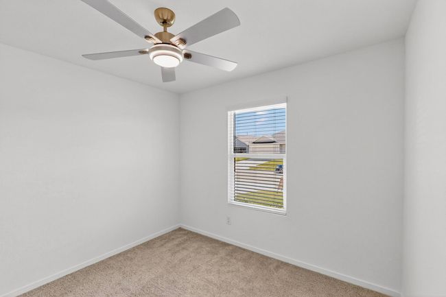 Empty room with light carpet, baseboards, and a ceiling fan | Image 22
