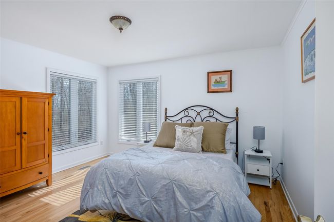 Bedroom featuring visible vents, baseboards, light wood-style flooring, and crown molding | Image 24