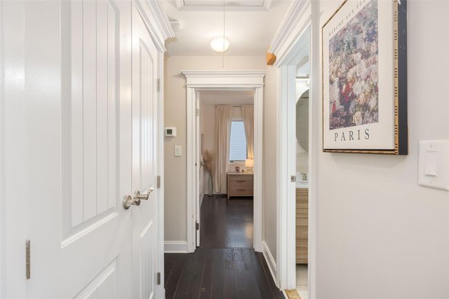 Corridor featuring attic access, baseboards, and dark wood-style floors | Image 29