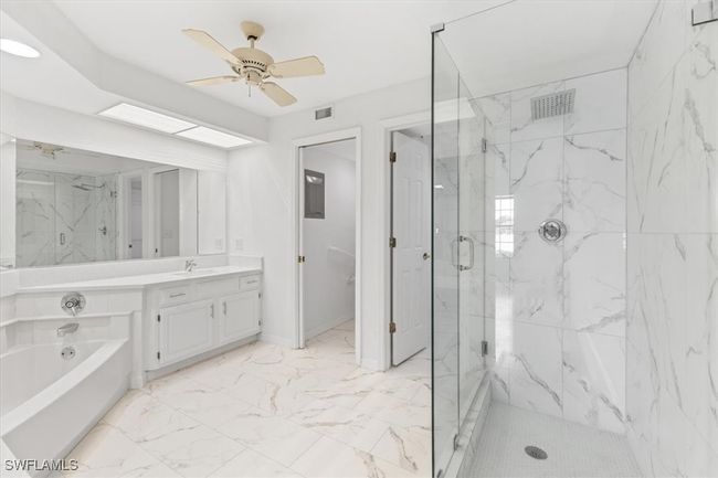 Bathroom with tile patterned flooring, separate shower and tub, vanity, and ceiling fan | Image 10