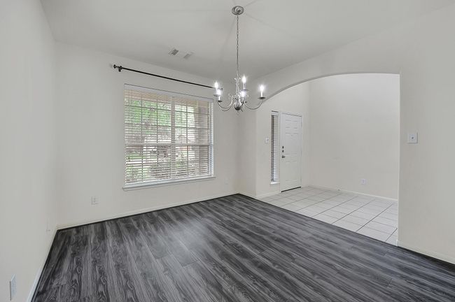 Alternate dining room view looking towards the tiled front door entryway. | Image 5