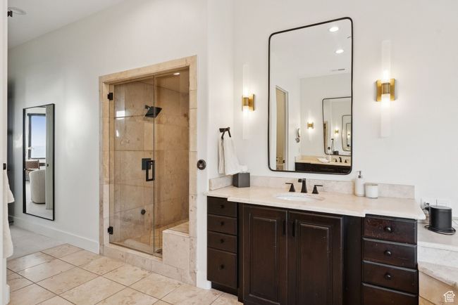 Bathroom featuring vanity, a shower stall, and tile patterned flooring | Image 40