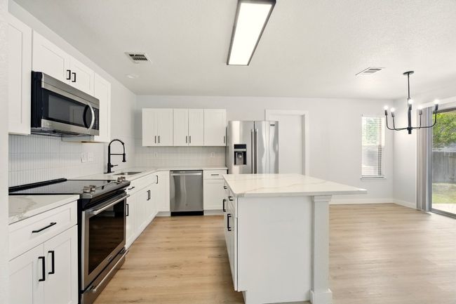 Kitchen featuring appliances with stainless steel finishes and a center island | Image 7