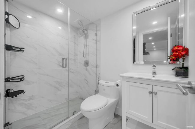 Full bath featuring recessed lighting, marble finish floor, toilet, vanity, and a marble finish shower | Image 8