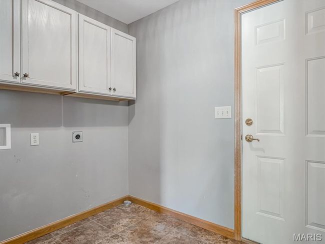 Washroom featuring hookup for an electric dryer and cabinet space | Image 15
