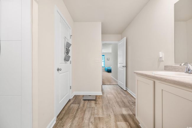 Full bathroom featuring wood finished floors, a shower stall, vanity, baseboards, and recessed lighting | Image 29