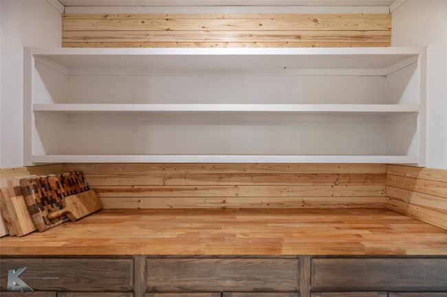 Room details featuring wooden walls | Image 13