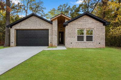 View of front of house with a front lawn and a garage | Image 1