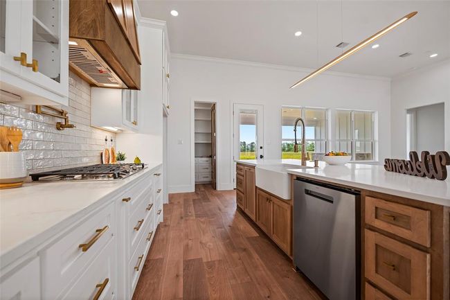 Modern kitchen with sleek cabinetry, elegant countertops, and high-end appliances. Bright and spacious, perfect for culinary enthusiasts. | Image 15