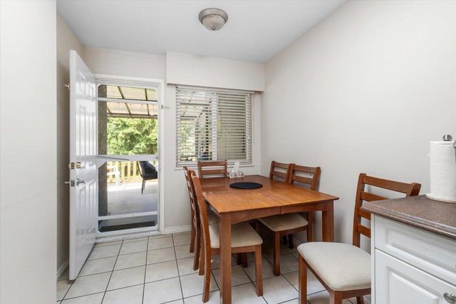 Dining area with light tile patterned floors and baseboards | Image 13
