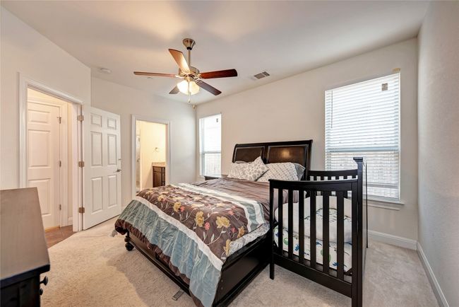 Bedroom featuring baseboards, ceiling fan, and light carpet | Image 8