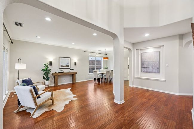 A bright and airy living room perfect for both quiet mornings and vibrant entertaining. | Image 13