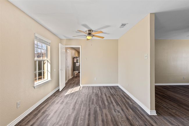 Dining room with dark wood-type flooring, visible vents, and baseboards | Image 13