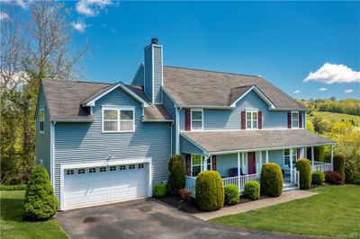 View of front of house with a garage, a front yard, and a porch | Image 2