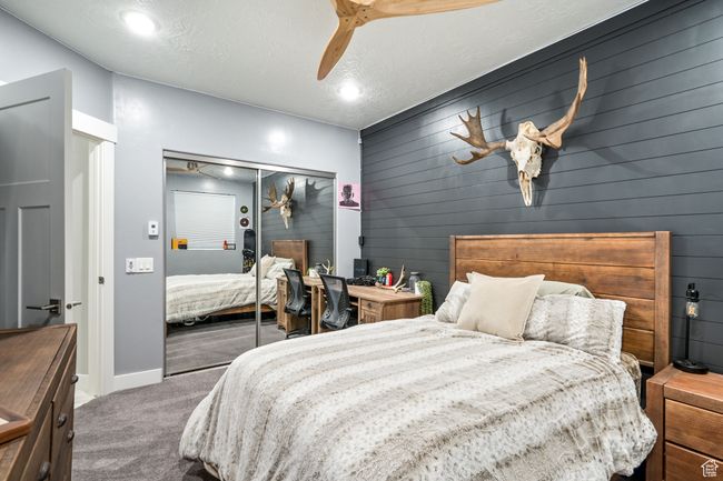 Bedroom featuring carpet floors, a closet, a ceiling fan, and recessed lighting | Image 78