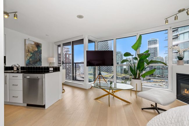Kitchen with stainless steel appliances, plenty of natural light, a peninsula, and a sink | Image 14