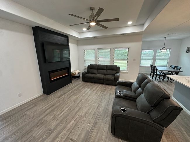 Back of property with a fenced backyard, roof with shingles, and brick siding | Image 28