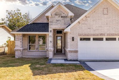 View of front of house featuring a front lawn and a garage | Image 2