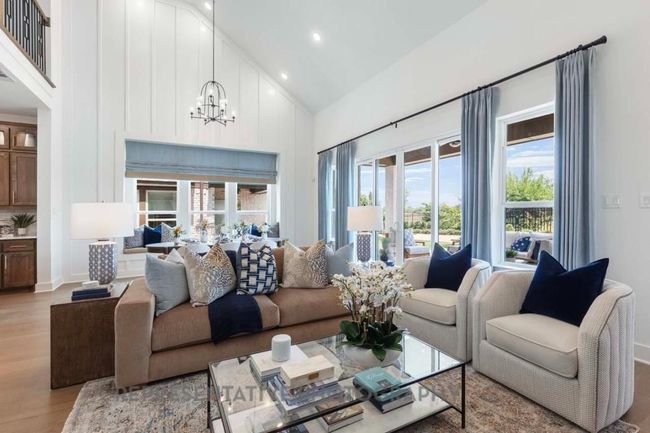 Living area featuring high vaulted ceiling, light wood-type flooring, a chandelier, and recessed lighting | Image 11