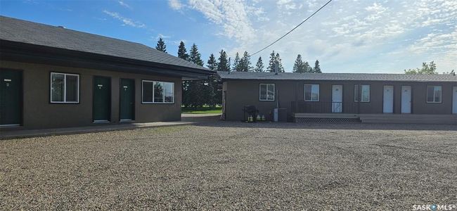 Back of property featuring stucco siding and a shingled roof | Image 14