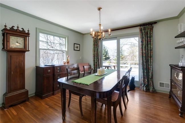 Dining room opens to the living room and kitchen. Cat does not come with the house. | Image 5